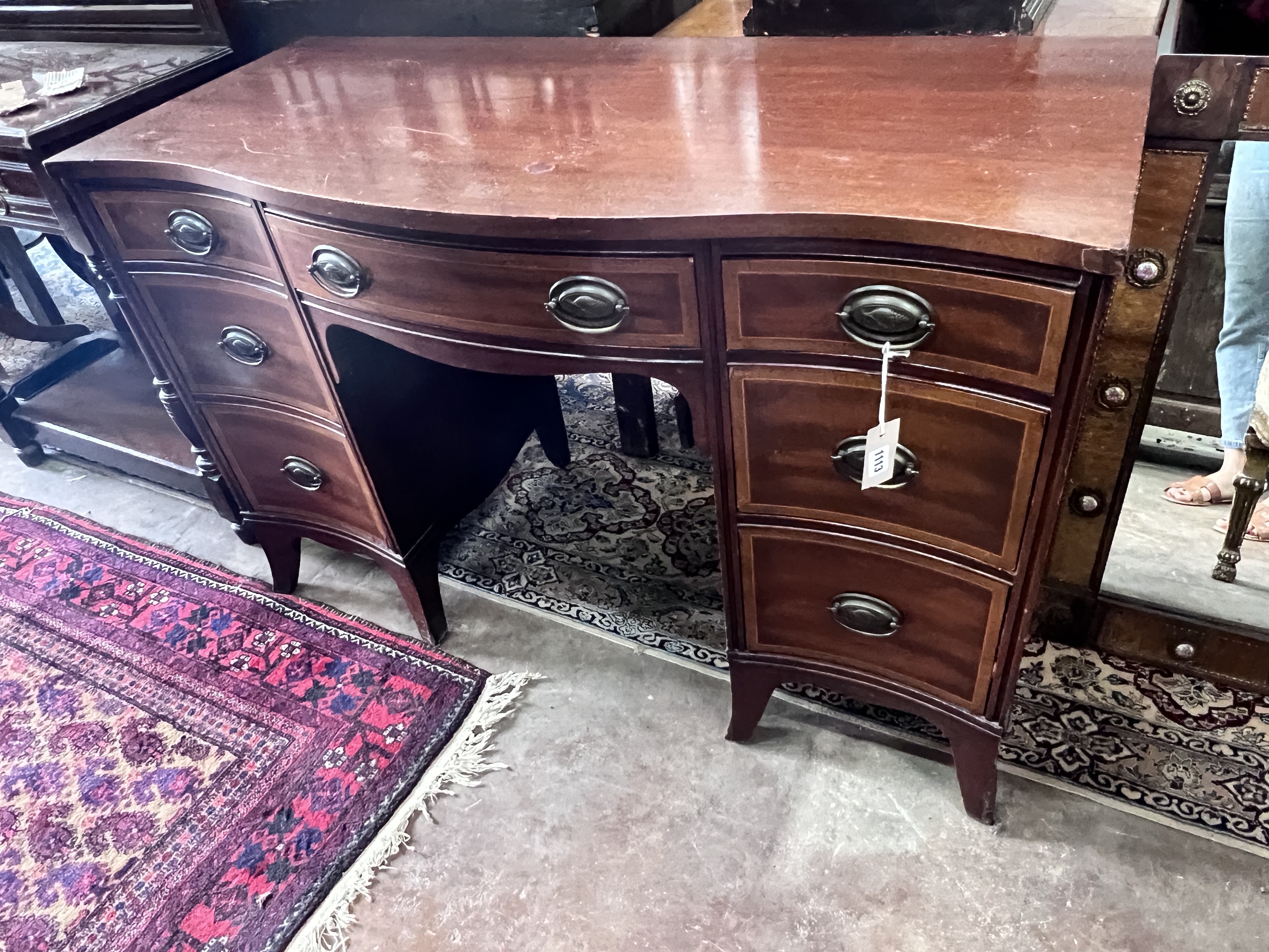 A reproduction 'Drexel Furniture' serpentine mahogany kneehole dressing table, width 117cm, width 51cm, height 77cm